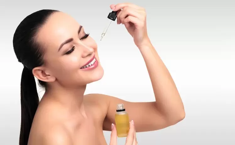 woman applying face serum